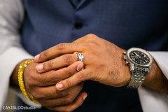 Indian groom putting his jewelry on. Indian groom putting his jewelry on.