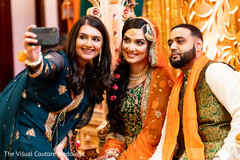 Indian bride and groom taking pictures with guest Indian bride and groom taking pictures with guest
