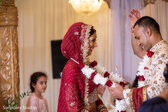Indian groom putting garland to bride at jaimala ritual. Indian groom putting garland to bride at jaimala ritual.