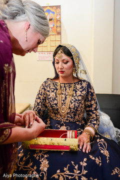 Indian bride being assisted by special guest Indian bride being assisted by special guest