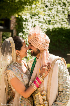 Indian couple posing outdoors on their ceremony outfits. Indian couple posing outdoors on their ceremony outfits.