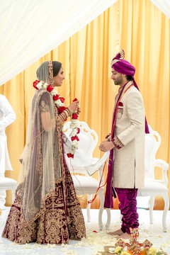 Indian bride putting the garland to groom ritual. Indian bride putting the garland to groom ritual.