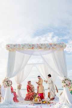 Indian couple under the lovely mandap Indian couple under the lovely mandap