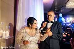Indian bride giving cake to groom. Indian bride giving cake to groom.