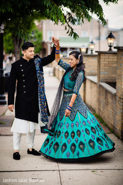 Indian bride and groom dancing outdoors Indian bride and groom dancing outdoors