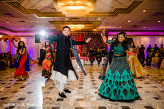 Indian groom and bride performing with dancers Indian groom and bride performing with dancers