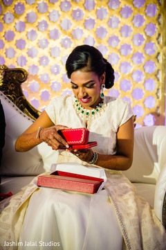 Indian bride opening up a present Indian bride opening up a present