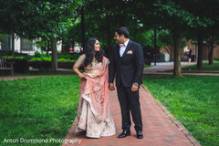 Indian bride and groom walking outdoors Indian bride and groom walking outdoors
