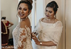 Joyful Indian bride getting her white dress on. Joyful Indian bride getting her white dress on.