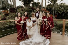 Indian bride and groom posing with bridesmaids and flower girl. Indian bride and groom posing with bridesmaids and flower girl.