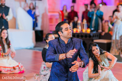 Indian groom dancing with bridesmaids at sangeet. Indian groom dancing with bridesmaids at sangeet.