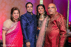 Joyful Indian couple posing with guests. Joyful Indian couple posing with guests.
