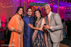 Charming Indian couple with sangeet guests capture. Charming Indian couple with sangeet guests capture.