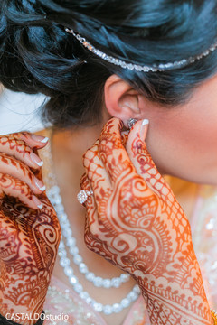 Indian bride getting her earrings on. Indian bride getting her earrings on.