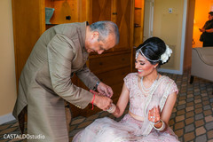 Indian bride's father putting an bracelete to bride. Indian bride's father putting an bracelete to bride.