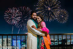 Indian couple posing with the fireworks Indian couple posing with the fireworks