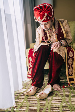 Charming indian groom getting his shoes on. Charming indian groom getting his shoes on.