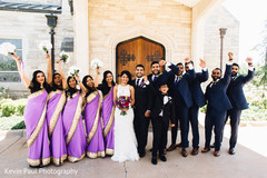 Indian bride posing with bridesmaids and groomsmen Indian bride posing with bridesmaids and groomsmen