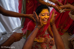 Indian bride is smeared in yellow turmeric paste . Indian bride is smeared in yellow turmeric paste .