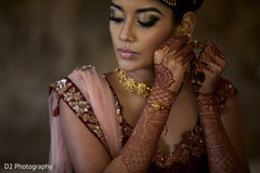 Indian bride punting her jewelry on. Indian bride punting her jewelry on.