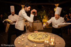 Indian bride and groom finishing their wedding Italian cake. Indian bride and groom finishing their wedding Italian cake.