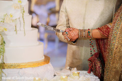Indian bride and groom cutting the cake Indian bride and groom cutting the cake
