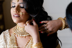 Indian bride getting her earrings on. Indian bride getting her earrings on.