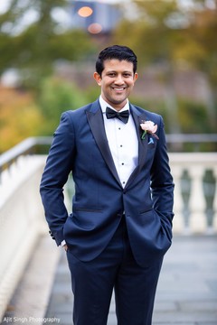 Elegant groom wearing the tux during the photo shoot Elegant groom wearing the tux during the photo shoot