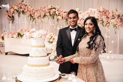 Indian bride and groom cutting the wedding cake Indian bride and groom cutting the wedding cake