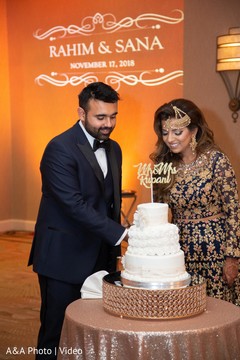 Indian bride and groom cutting the wedding cake Indian bride and groom cutting the wedding cake