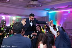 Indian groom being lifted by guests Indian groom being lifted by guests