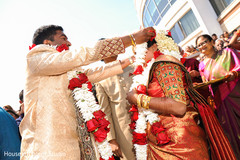 Indian groom putting garland to bride. Indian groom putting garland to bride.