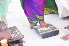Indian bride climbing over a stone ritual. Indian bride climbing over a stone ritual.