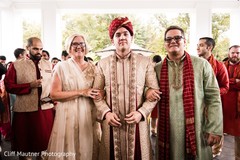 Indian groom with parents during his baraat celebration. Indian groom with parents during his baraat celebration.