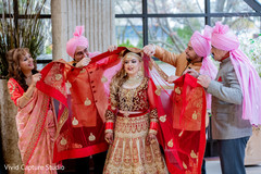 Indian bride being assisted by family Indian bride being assisted by family