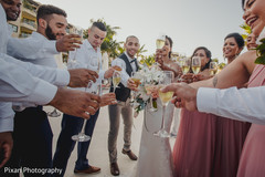 Indian couple with bridesmaids and groomsmen toast. Indian couple with bridesmaids and groomsmen toast.