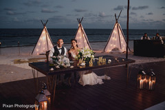 Indian couple at their wedding reception table. Indian couple at their wedding reception table.
