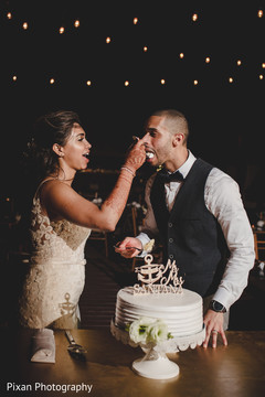 Indian wedding cutting the cake scene Indian wedding cutting the cake scene