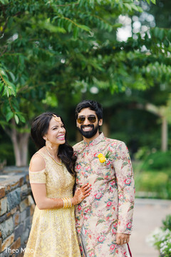 Indian bride and groom smiling as they pose Indian bride and groom smiling as they pose