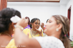 Indian bride getting the final makeup touches Indian bride getting the final makeup touches