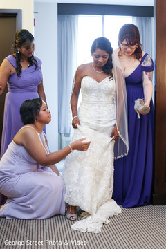 Indian bridesmaids helping maharani getting ready Indian bridesmaids helping maharani getting ready