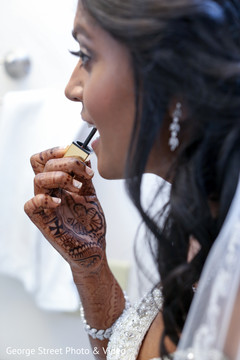 Indian bride putting lipstick on Indian bride putting lipstick on