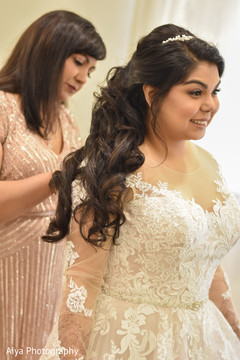 Indian bride putting her white wedding dress. Indian bride putting her white wedding dress.