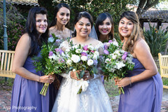 Indian bride with bridesmaids posing outdoors. Indian bride with bridesmaids posing outdoors.