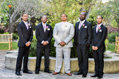 Indian groom posing outdoors with groomsmen. Indian groom posing outdoors with groomsmen.