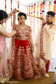 Indian bride getting her ghoonghat on. Indian bride getting her ghoonghat on.