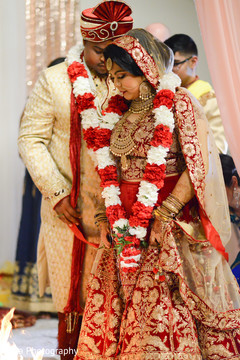 Indian bride and groom walking the seven steps around sacred fire. Indian bride and groom walking the seven steps around sacred fire.