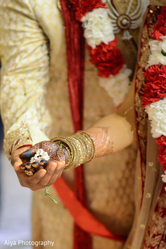 Indian bride and groom holding a special ritual item. Indian bride and groom holding a special ritual item.