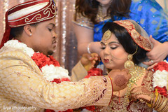 Indian bride getting blessed chain from groom. Indian bride getting blessed chain from groom.
