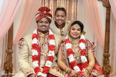 Sweet indian couple posing with best man. Sweet indian couple posing with best man.